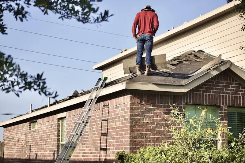 Professional roofer working on a residential roof in Sherwood Acres